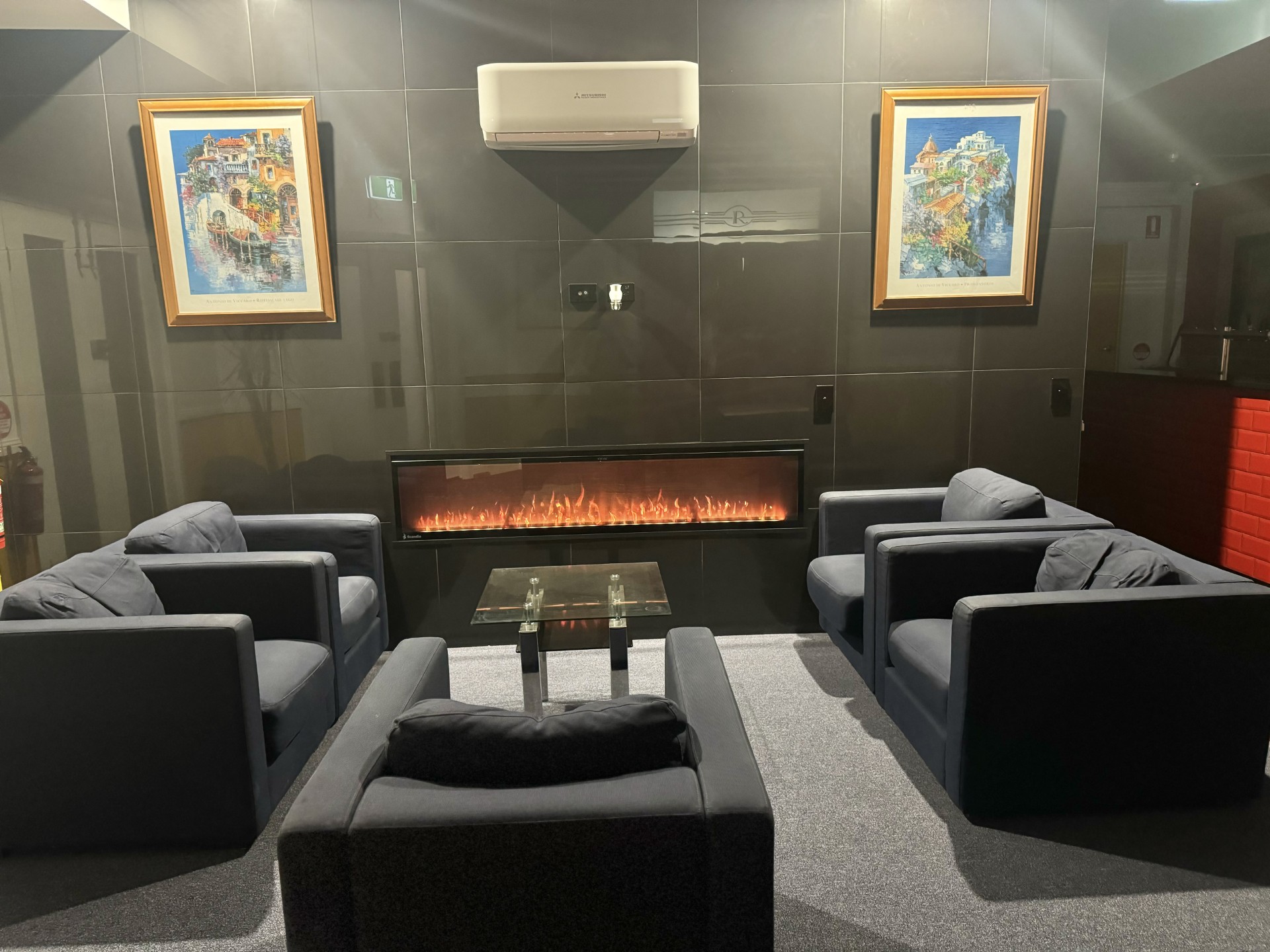 Large guest lounge with a modern fireplace and comfortable sofas