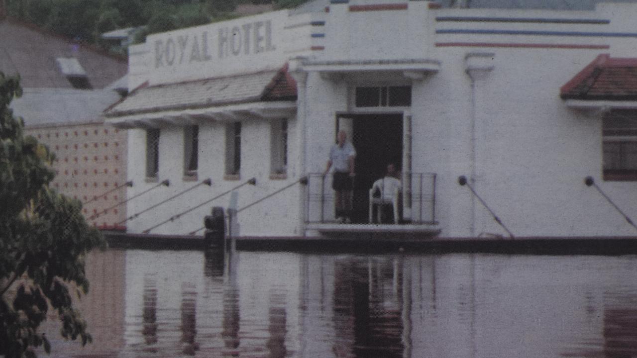 The Royal Hotel during an earlier flood, guests watching from the verandah