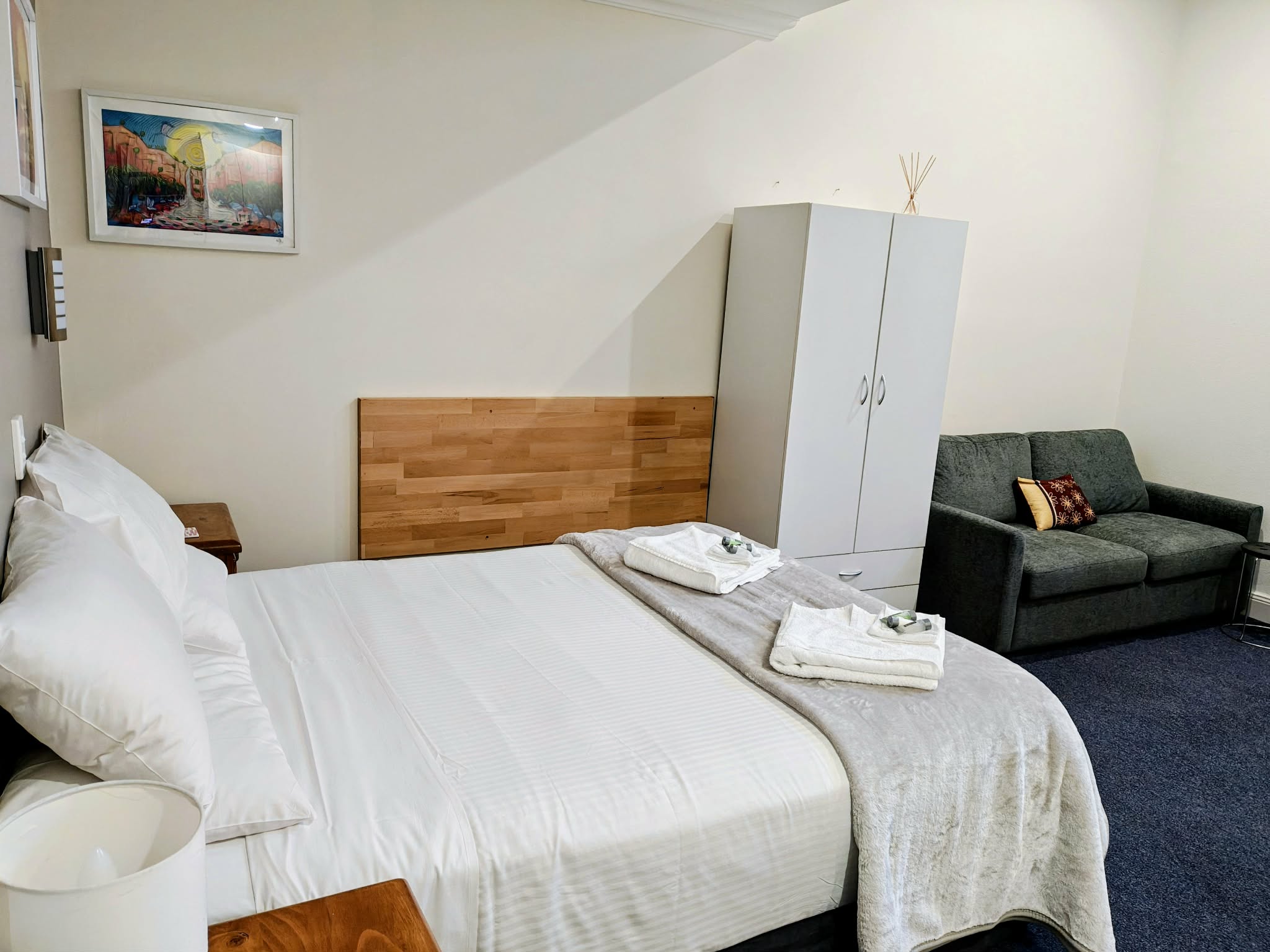 Premium Room 20 queen bed with lounge seating and wardrobe