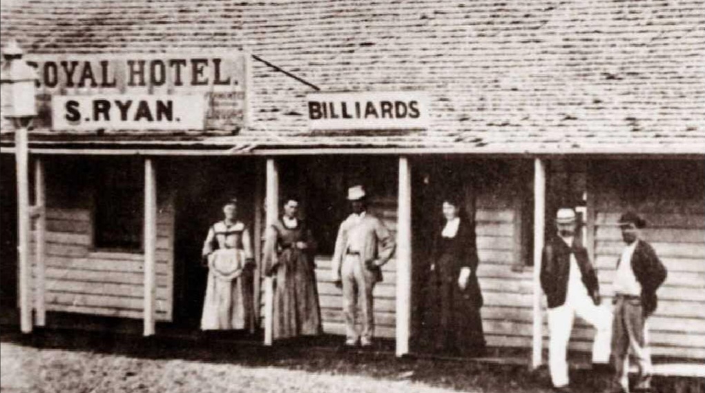 The early Royal Hotel in the 1800s with patrons on the verandah